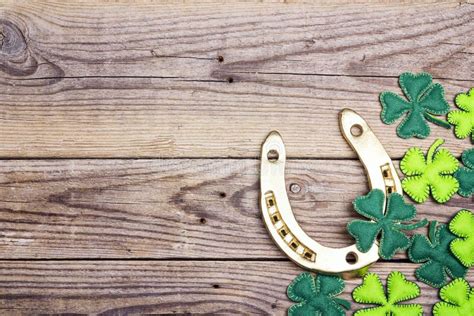 Horseshoe With Clover Leaf Frame On Old Wooden Boards St Patricks Day