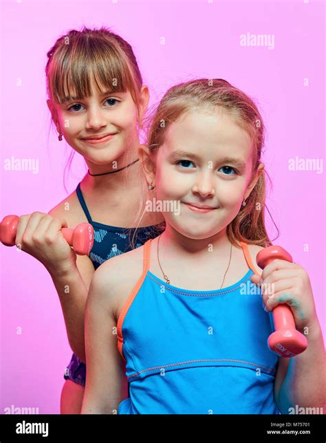 Little Funny Girls In Swimwear With Dumbbells Stock Photo Alamy