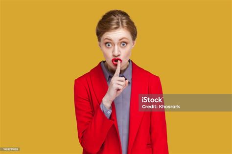 Strict Bossy Woman With Red Lips Standing Looking At Camera Showing Shh Gesture Asking To Be