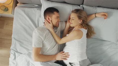 Pregnant Couple Cuddling Together In Bed Stock Video Footage Dissolve