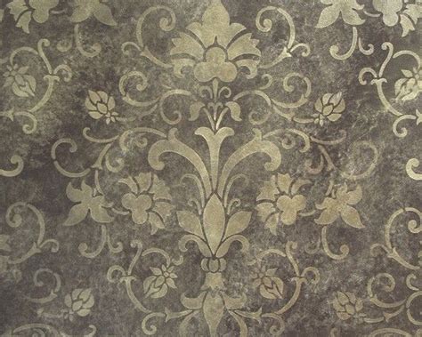 An Old Wallpaper With Gold And White Designs On Its Surface As Well