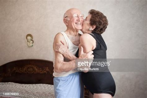 Happy Elderly Couple Hugging In A Bedroom Photo Getty Images