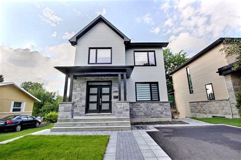 Tradition 2 Story Contemporary House With Gray Siding And Gray Stone