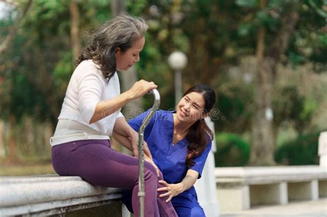 Healthcare Nurse Physical Therapy With Elderly Woman At Outdoor Nurse