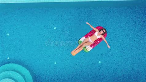 Top View Aerial Photo Of A Seductive Model In Black Swimwear Is Enjoying Relax In Hotel Pool