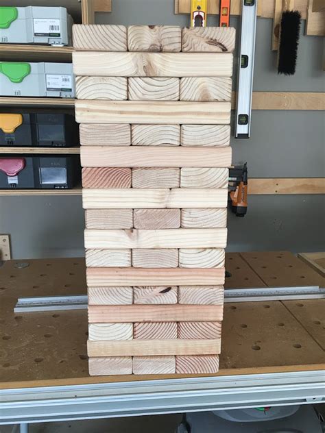 Players take turns removing one block at a time from a tower. How to Build a DIY Giant Jenga Yard Game in Just TWO Hours and Only TWENTY Dollars