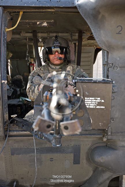 A Uh 60 Black Hawk Door Gunner Manning A M240b Machine Gun Stocktrek