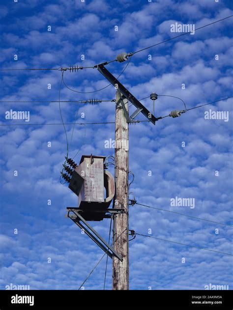 Electricity Transformer Pole Against A Dappled Blue Sky Stock Photo Alamy