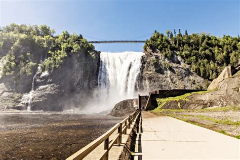 Blue Lake And Powerful Waterfall Montmorency In Montmorency Falls Park