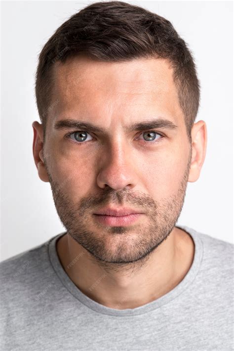 Premium Photo Portrait Of Serious Handsome Man Looking At Camera Against White Background