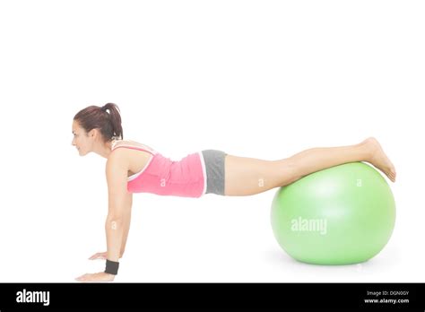 Content Sporty Brunette Doing Exercise With Exercise Ball Stock Photo