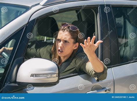 Angry Woman Stuck In A Traffic Jam Shouting At Someone Stock Photo