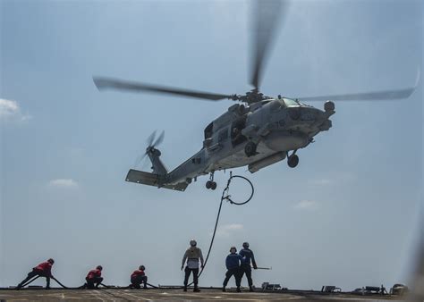 Sailors Send A Fuel Line Up To An Mh 60r Sea Hawk Helicopter During