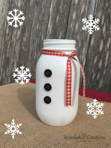 A Snowman Mason Jar With Buttons On It