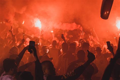 Crowd Holding Flares While Gathered On Open Area At Night Time · Free