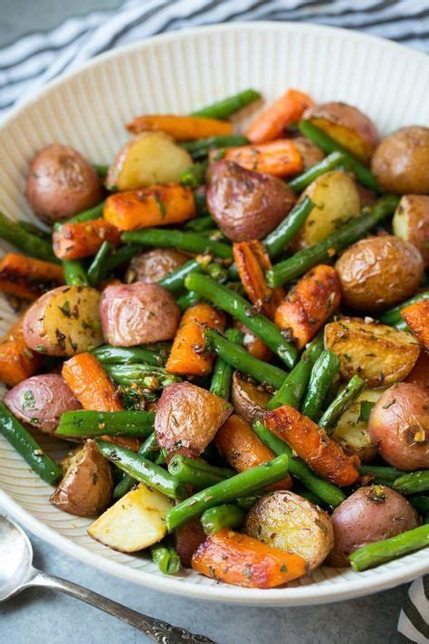 In a large bowl toss together potatoes, carrots with 2 1/2 tbsp olive oil, thyme, rosemary and season with salt and pepper to taste. Garlic Herb Roasted Potatoes Carrots and Green Beans ...