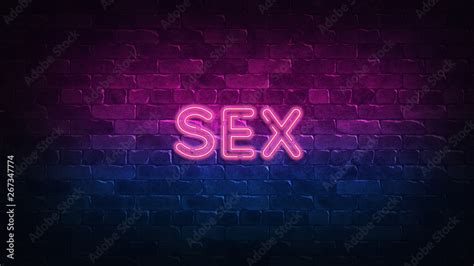 sex neon sign purple and blue glow neon text brick wall lit by neon lamps night lighting on