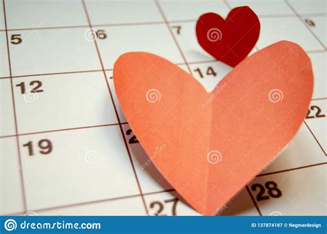 Paper Red Hearts Marking 14 February Valentines Day On White Calendar
