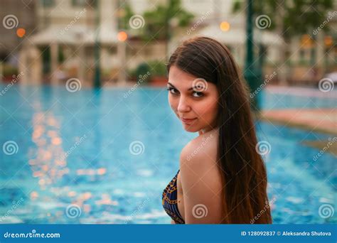 Portrait Of Woman Sitting On Edge Of Swimming Pool Wearing Bikini Sexiezpix Web Porn