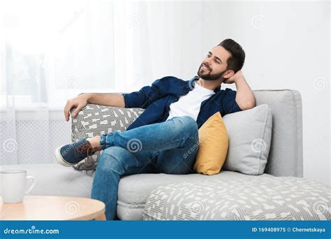 Young Man Relaxing On Couch Stock Image Image Of Calm Lounge 169408975