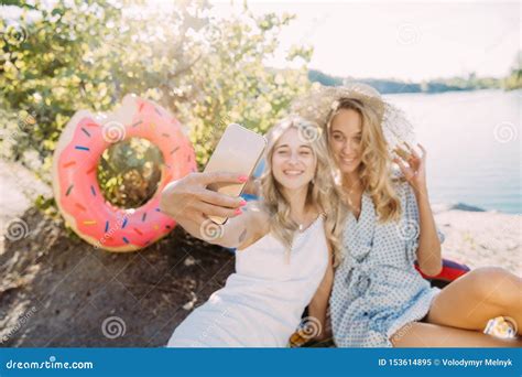 Young Lesbian`s Couple Having Fun And Spending Time At Riverside In Sunny Day Stock Image