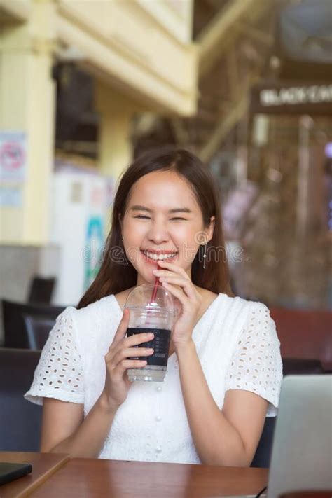 Lovely Asian Woman Wearing Glasses Sitting At Coffee Shop Stock Image