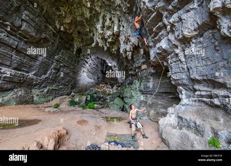 Male Climbers At Treasure Cave In Yangshuo Guangxi Zhuang China Stock