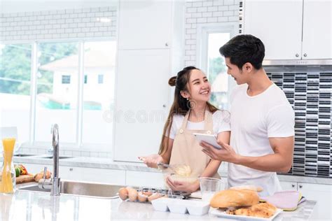 Asian Couples Feeding Food Together In Kitchen People And Lifestyles Concept Sweet Honeymoon