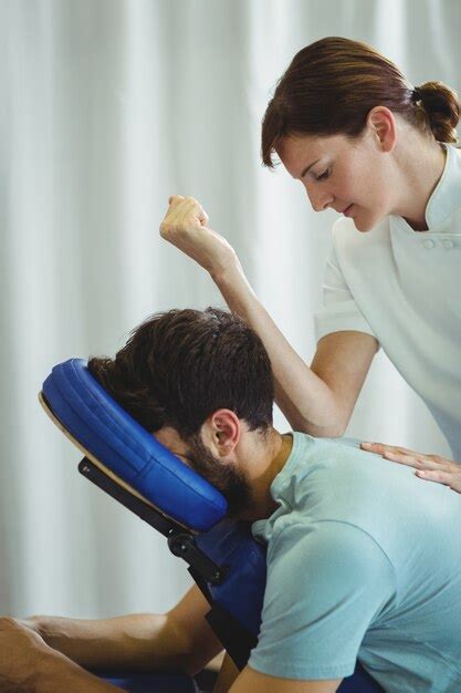 Physiotherapist Giving Back Massage To A Patient Premium Photo