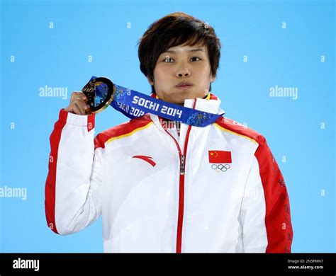 women s 500 meter short track speedskating gold medalist li jianrou of china holds her medal