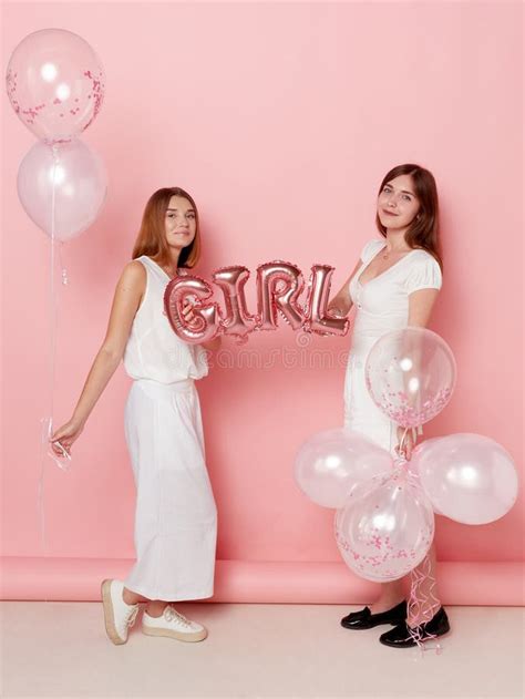Full Length Image Of A Two Of Happy Young Women Dressed In A White