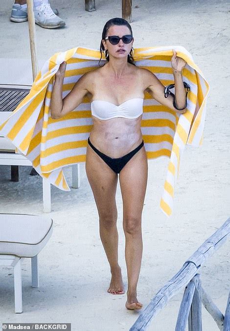 Penelope Cruz Flashes Taut Tummy As She Swims With Husband Javier Bardem In Monte Argentario