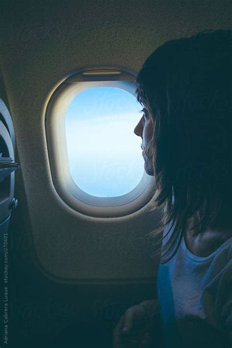 Lass Looking Out To The Window Of The Plane By Stocksy Contributor