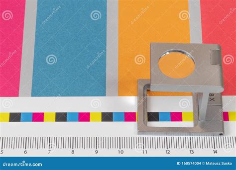 Silver Magnifying Glass Standing On The Test Print Colored Background