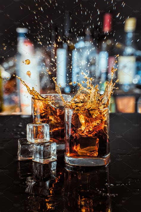 Glasses Of Whiskey With Splash On Bar Background ~ Food And Drink Photos ~ Creative Market
