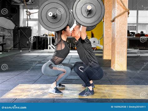 Fitness Couple Making A Barbell Jerk And Kissing Each Other Sporty
