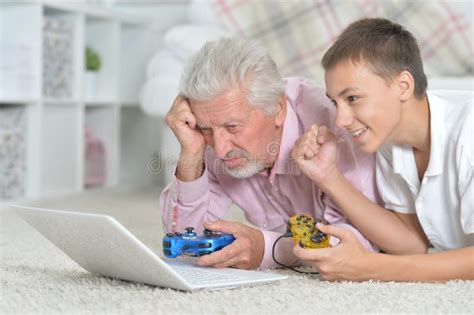Grandfather And Grandson Playing Computer Games Stock Image Image Of