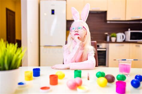 Cute Little Girl Painting Easter Eggs Wear Bunny Ears In Kitchen Stock