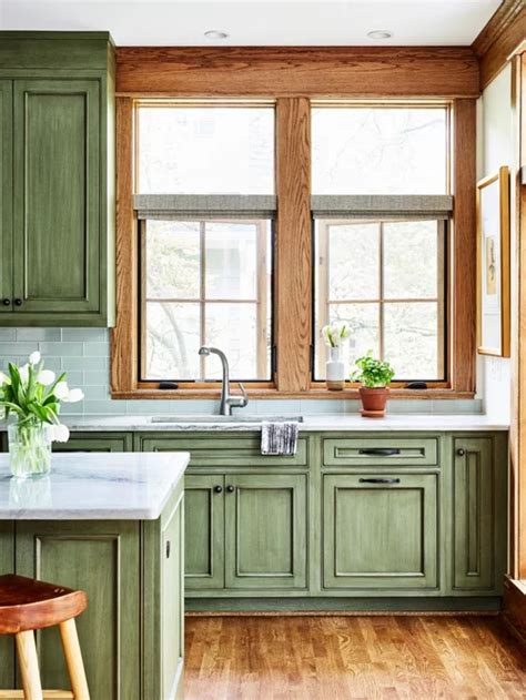 • traditional paneled cabinets give your kitchen a tailored look. Del Ray Sears Bungalow | Stained kitchen cabinets, Green ...