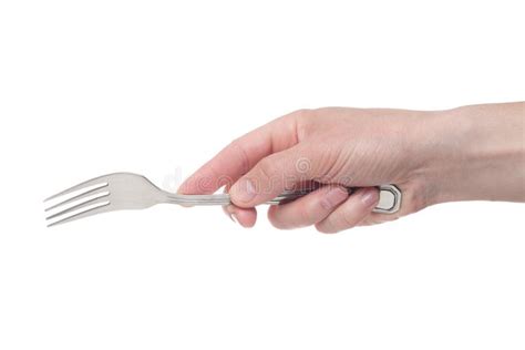 Hand Holding A Silver Fork On An Isolated White Background Stock Photo