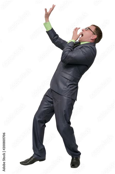 scared businessman looks up screams with fear and hands over his face isolated on white