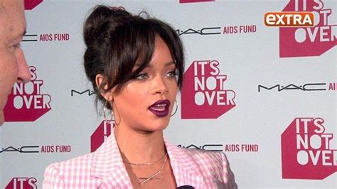 rihanna takes the plunge and goes shirtless underneath a conservative pink checked suit checked