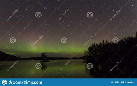Northern Lights Aurora Borealis Over A Lake In Sweden Stock Image