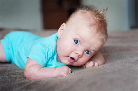 Little Baby Boy Lying On Soft Blanket In Room Stock Photo Image Of