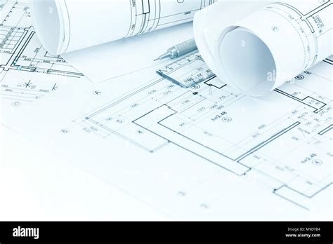 Architectural Project Plans And Roll Blueprints With Pencil And Ruler