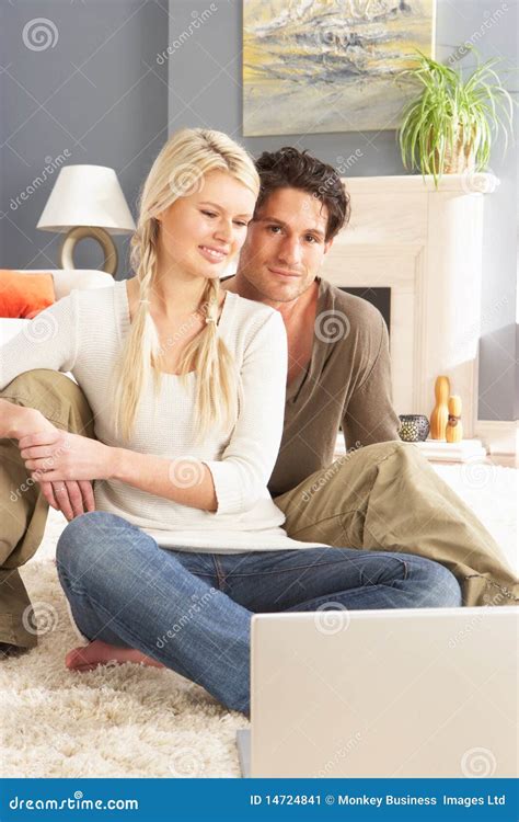 couple using laptop relaxing sitting on rug stock image image of three adult 14724841