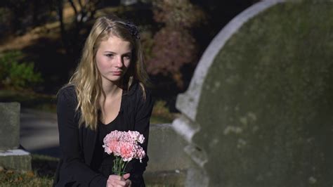 Sad Girl Sitting At Gravestone In Cemetery Stock Footage Sbv 311167927