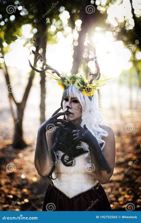Vertical Shot Of A Woman With Deer Antlers Flowers And Makeup In The