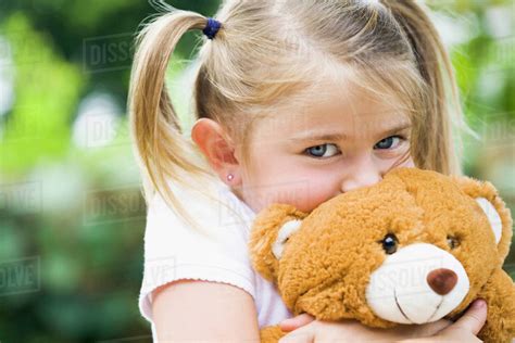 Girl Hugging Teddy Bear Stock Photo Dissolve