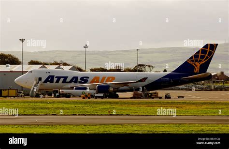 An Atlas Air Boeing 747 Cargo Airplane Refueling On The Tarmac At